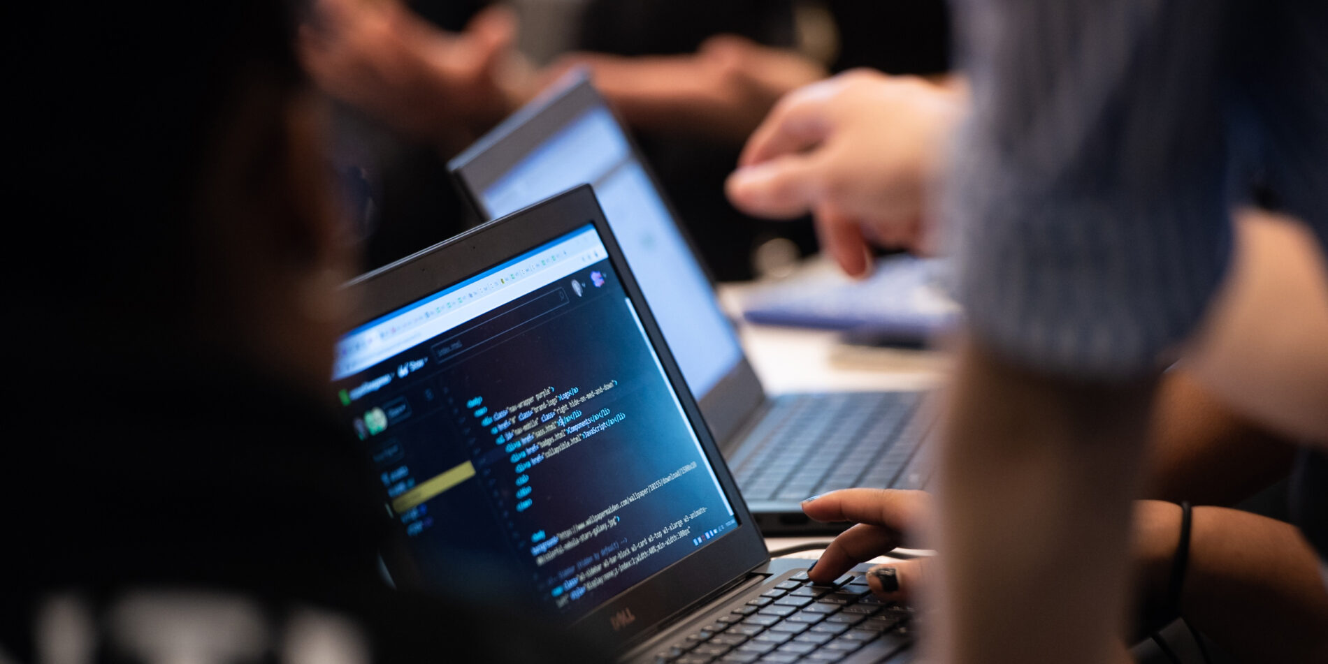 Accessibility Hero Image - close up of people coding on laptops