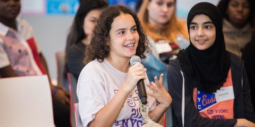 Stories and Insights Hero- Student with a microphone in audience