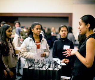 Students talking to employer